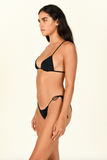 Model standing to the side wearing the via top and ties bottom in black