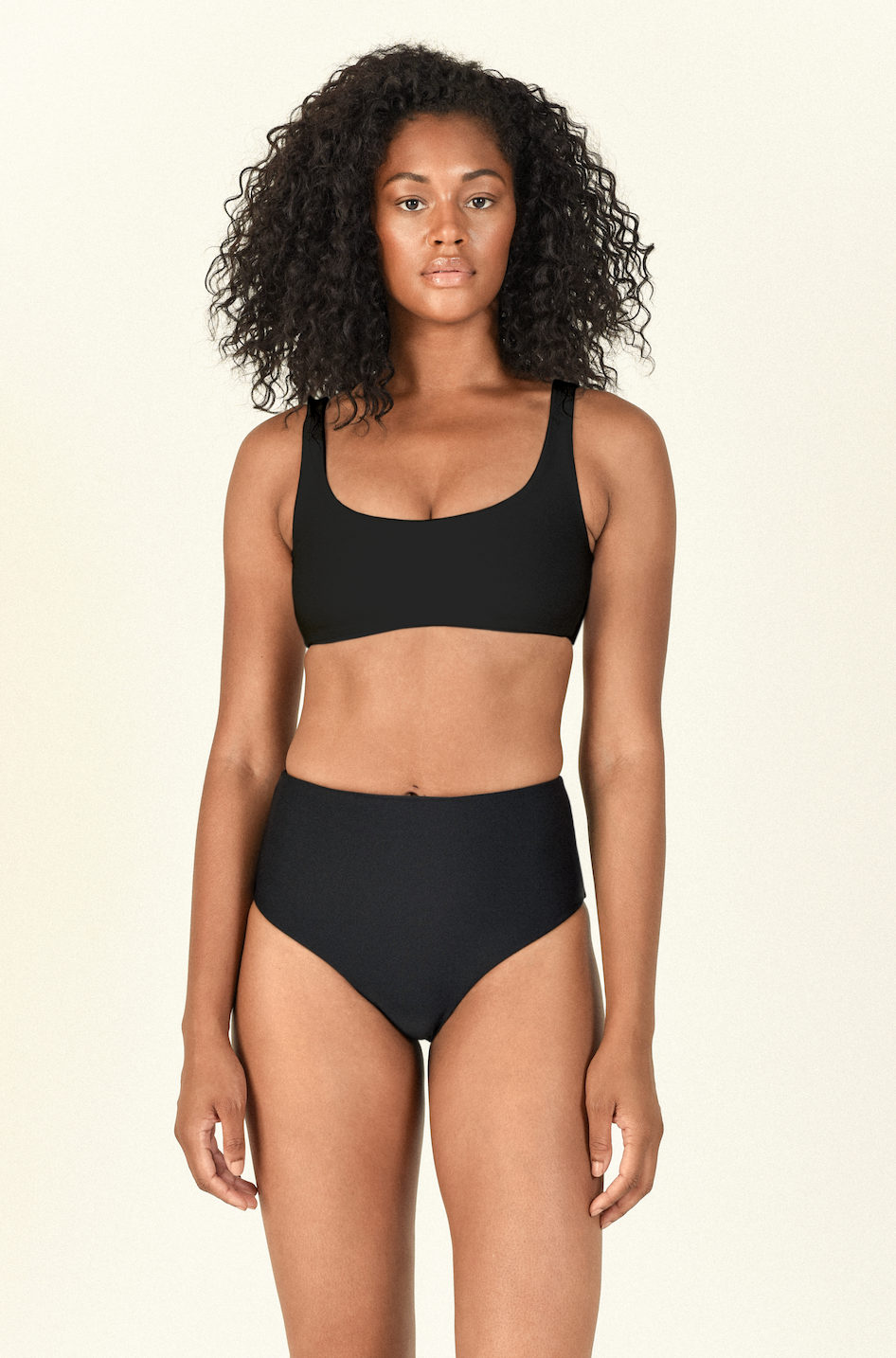 Model standing wearing the Rounded Edges Top and Bound Bottom in Black