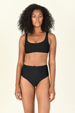 Model standing wearing the Rounded Edges Top and Bound Bottom in Black