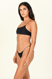 Model standing to the side wearing the Micro Muse Scoop Top and Micro Bare Minimum Bottom in Black