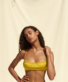 Model standing with hand on her hip wearing the Remi Top in Citron Sheen