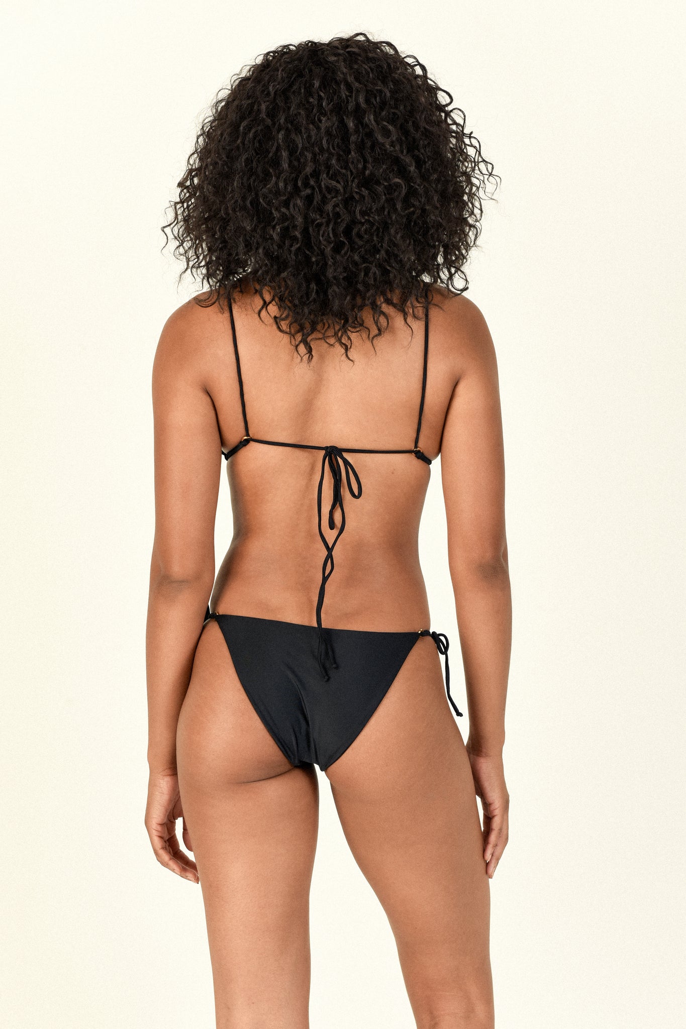 Load image into Gallery viewer, Model showing the back of the Lido Top and Loop Bottom in black