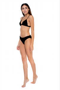 Model standing to the side wearing the perfect match top and lure bottom in black