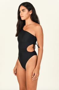 Model standing to the side wearing the Sena One Piece in black