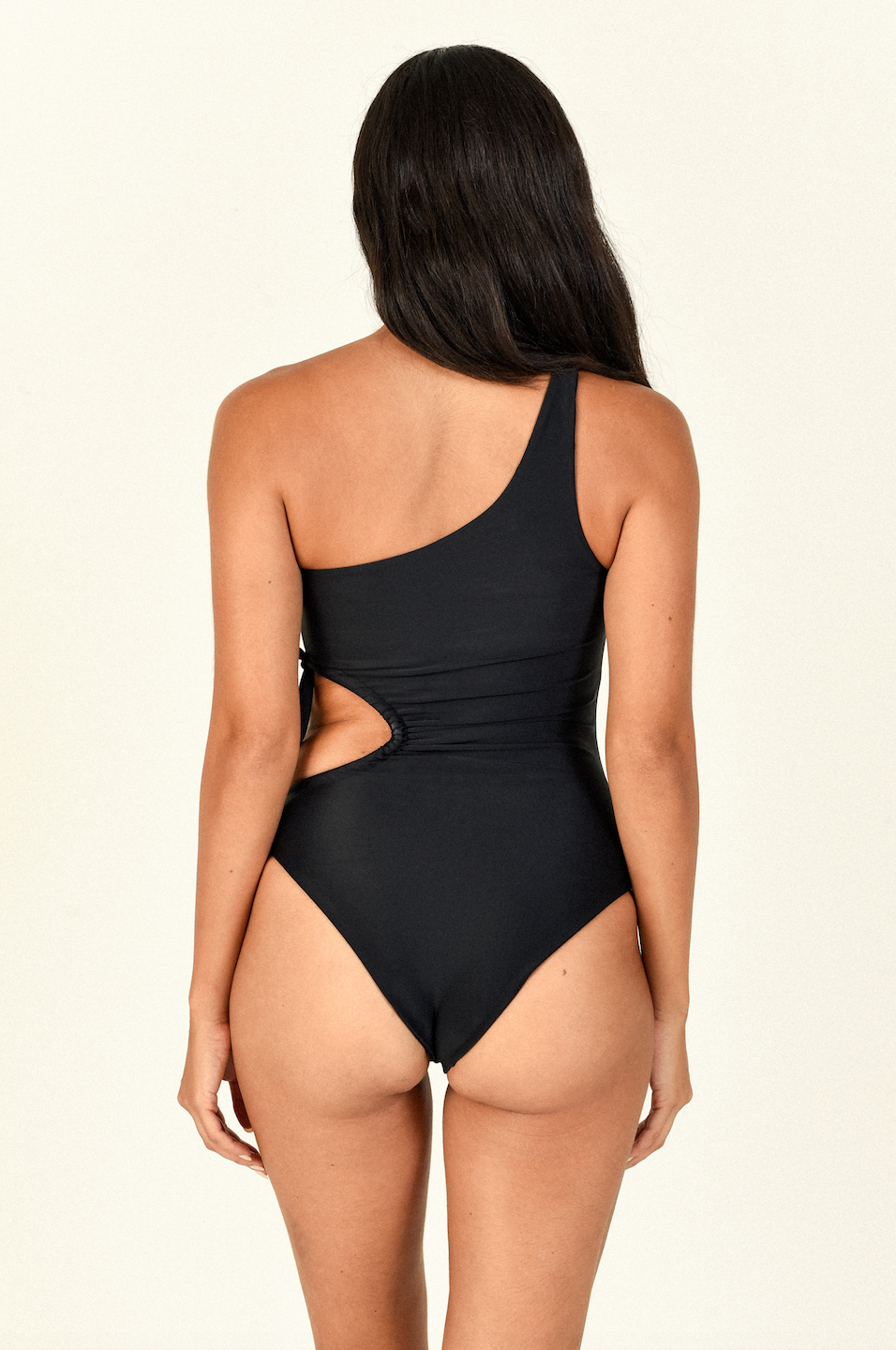 Load image into Gallery viewer, Model standing to the back wearing the Sena One Piece in black