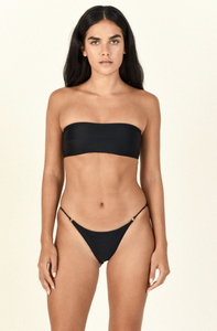Model in front of background wearing the All Around Bandeau in black