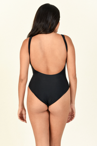 Model standing backwards against white background wearing the Contour One Piece in black