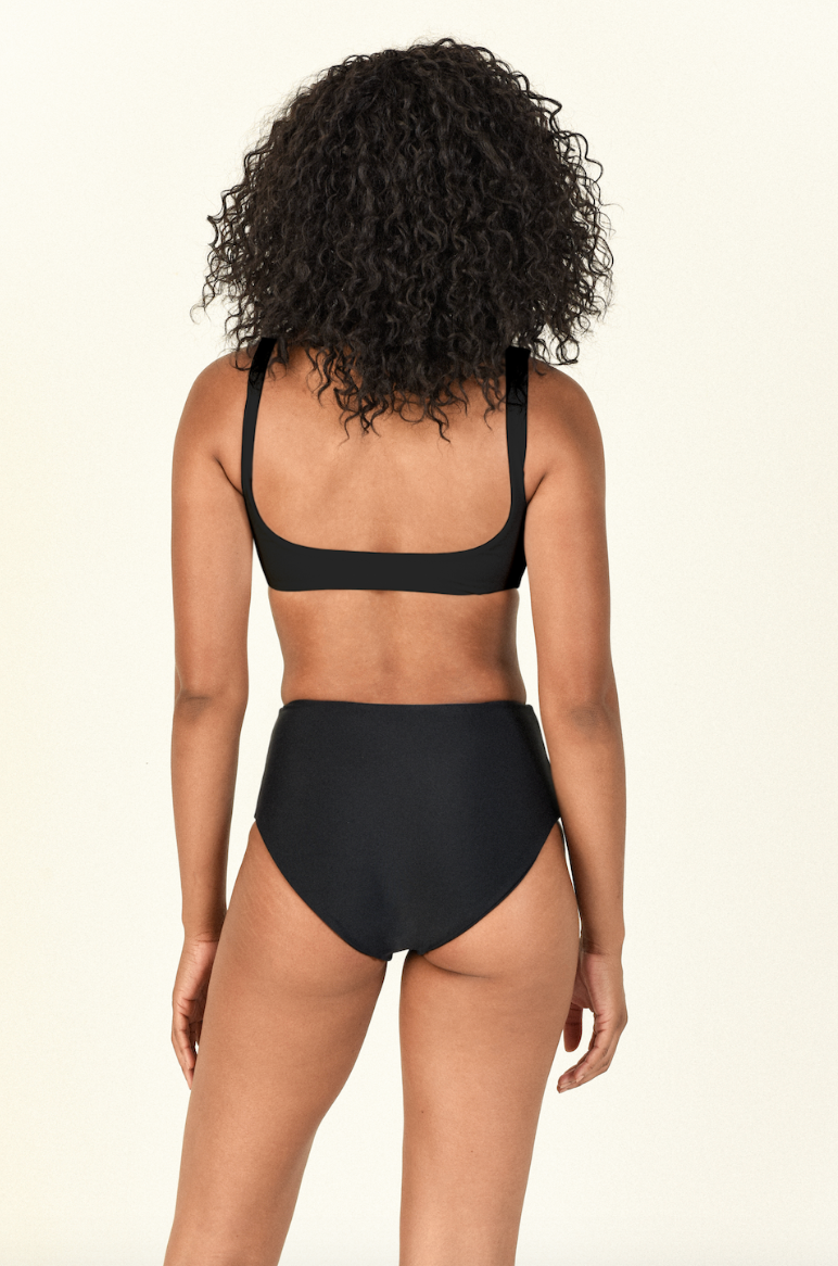 Model against white background showing the back of the Rounded Edges Top and Bound Bottom in Black