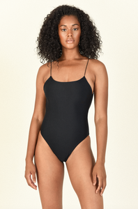 Model standing wearing the Micro Trophy One Piece in Black